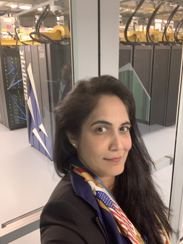 Profile picture of Sarayu Srinivasan in front of Summit, the fastest supercomputer in the world.